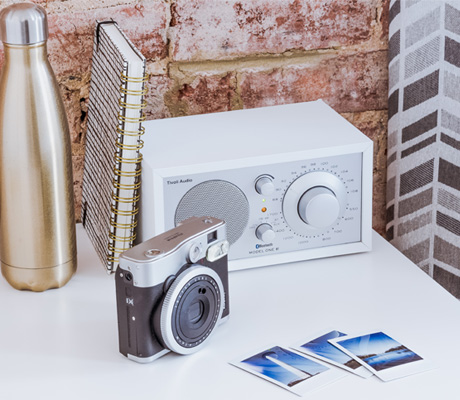 camera, water bottle, clock radio