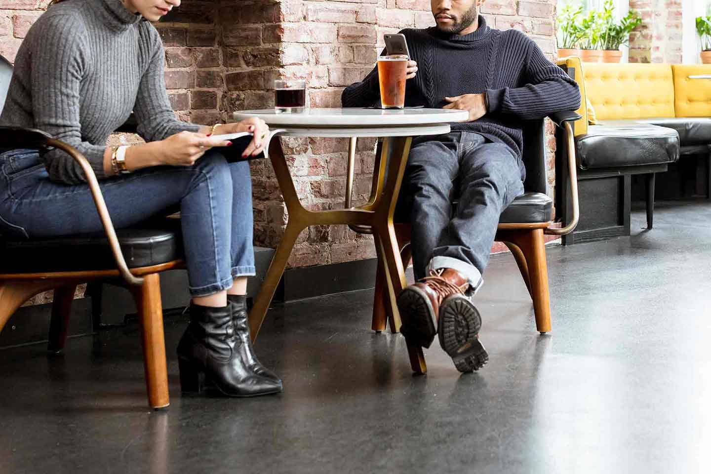 Couple in wool sweaters relaxing at coffee shop